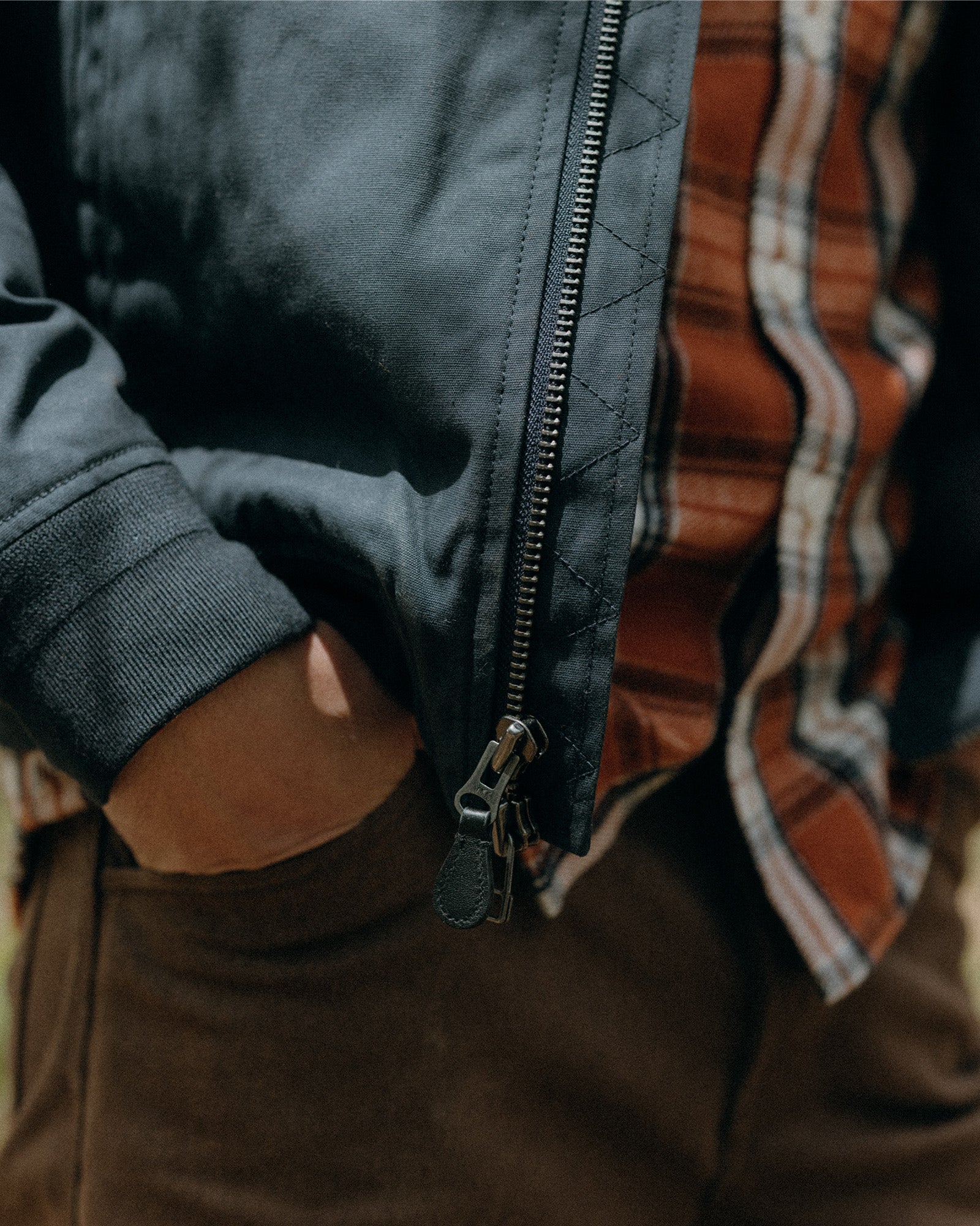 fit model with his hands in his pockets wearing The Camp Pant in Aged Penny Chipped Canvas, Bottoms by Taylor Stitch