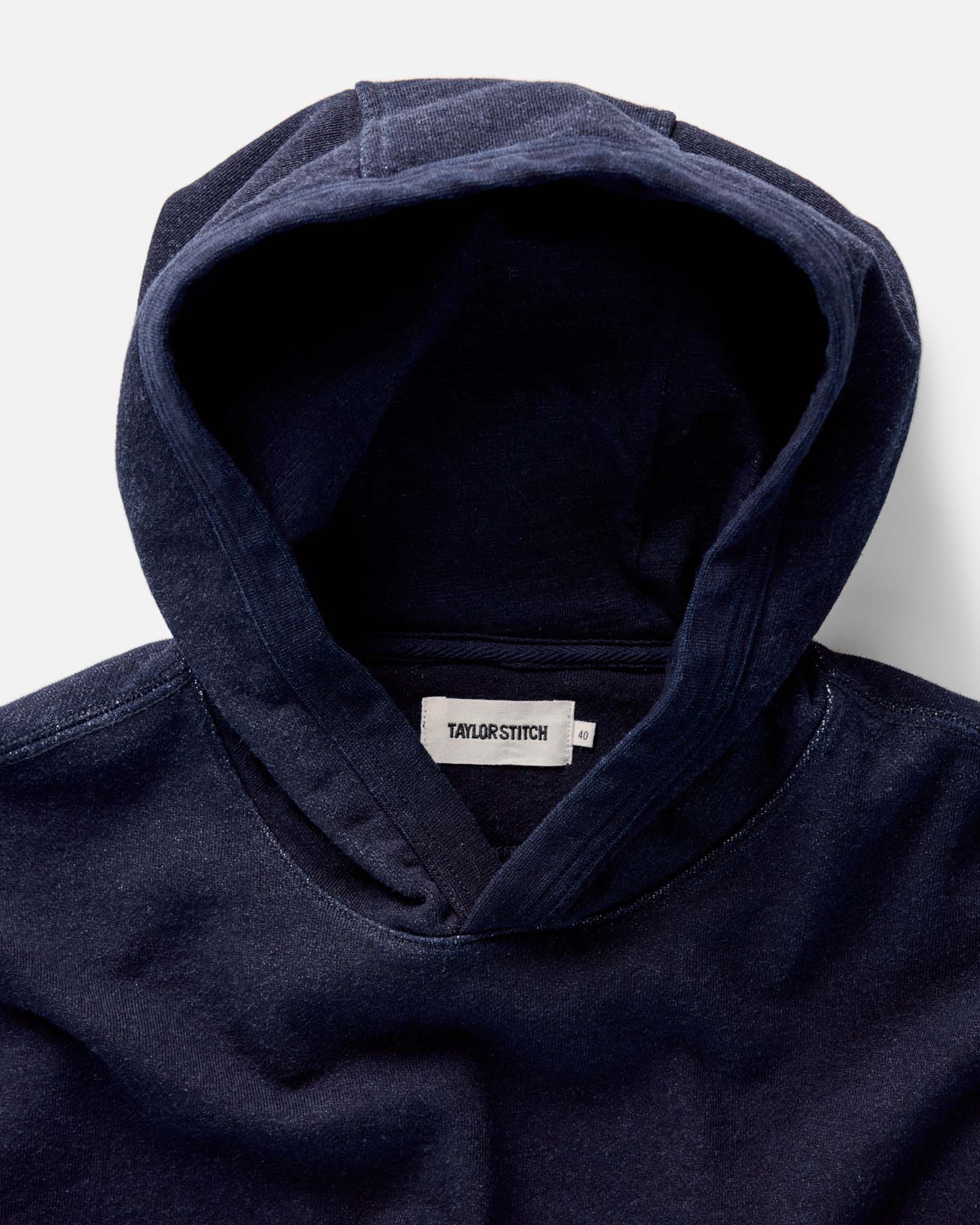 fit model with his hands in the kangaroo pocket of The Apres Hoodie in Indigo Terry, Knits by Taylor Stitch