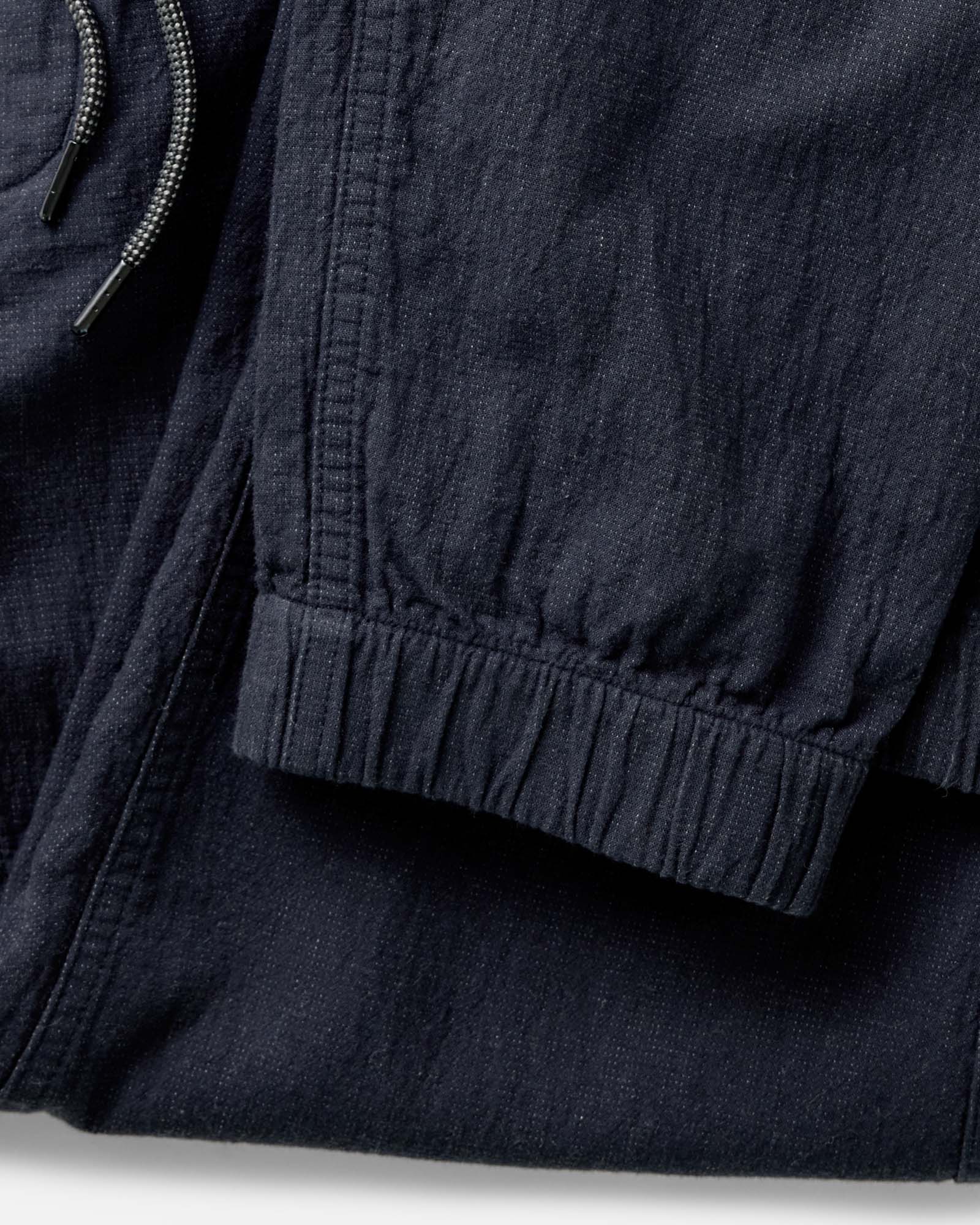 material shot of the cuffs on The Apres Pant in Coal Double Cloth, Bottoms by Taylor Stitch