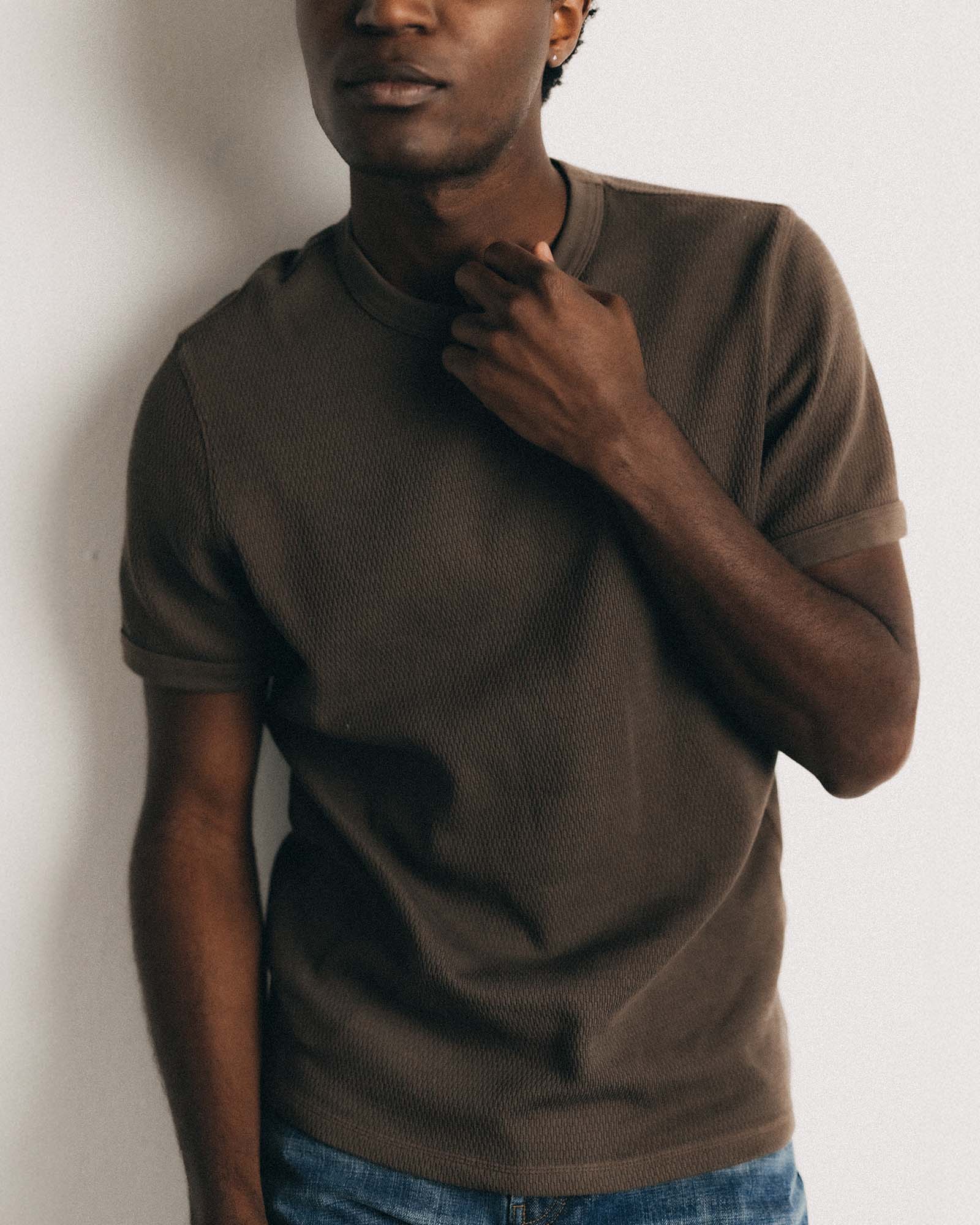 fit model wearing The Organic Cotton Short Sleeve Crew in Fatigue Olive Waffle, Knits by Taylor Stitch