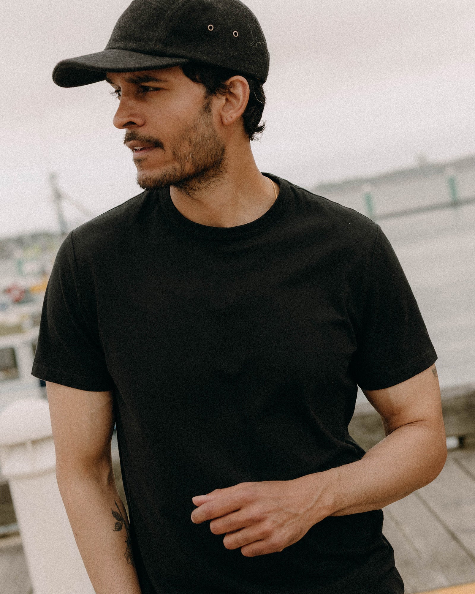 fit model posing in The Organic Cotton Tee in Black, Knits by Taylor Stitch