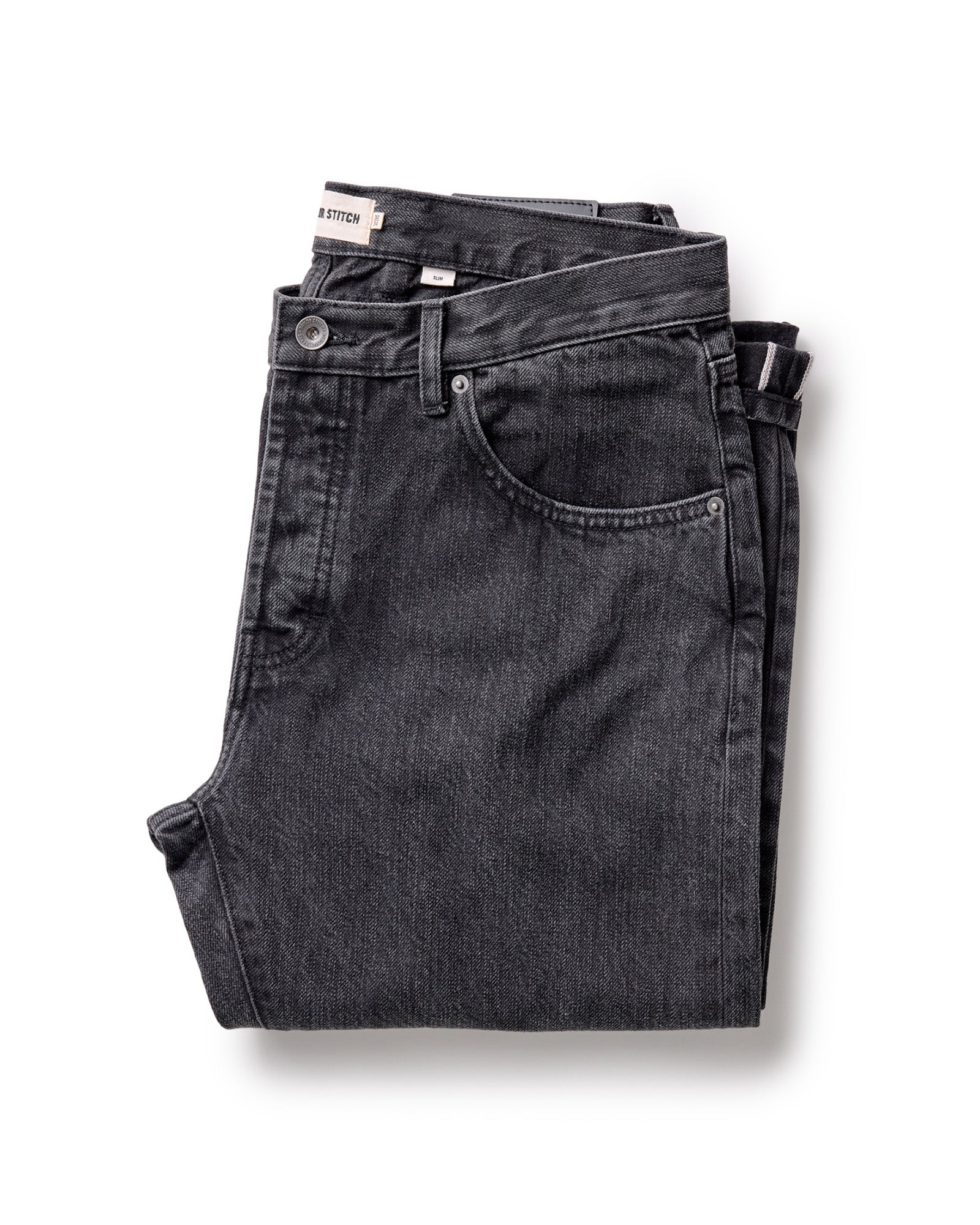 folded flatlay of The Slim Jean in Washed Black Organic Slub Selvedge, Bottoms by Taylor Stitch