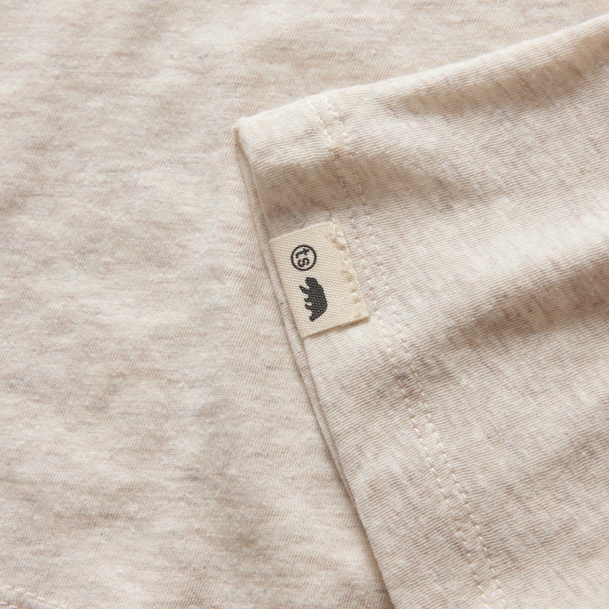 material shot of the logo tag on The Cotton Hemp Tee in Heather Oat, Knits by Taylor Stitch