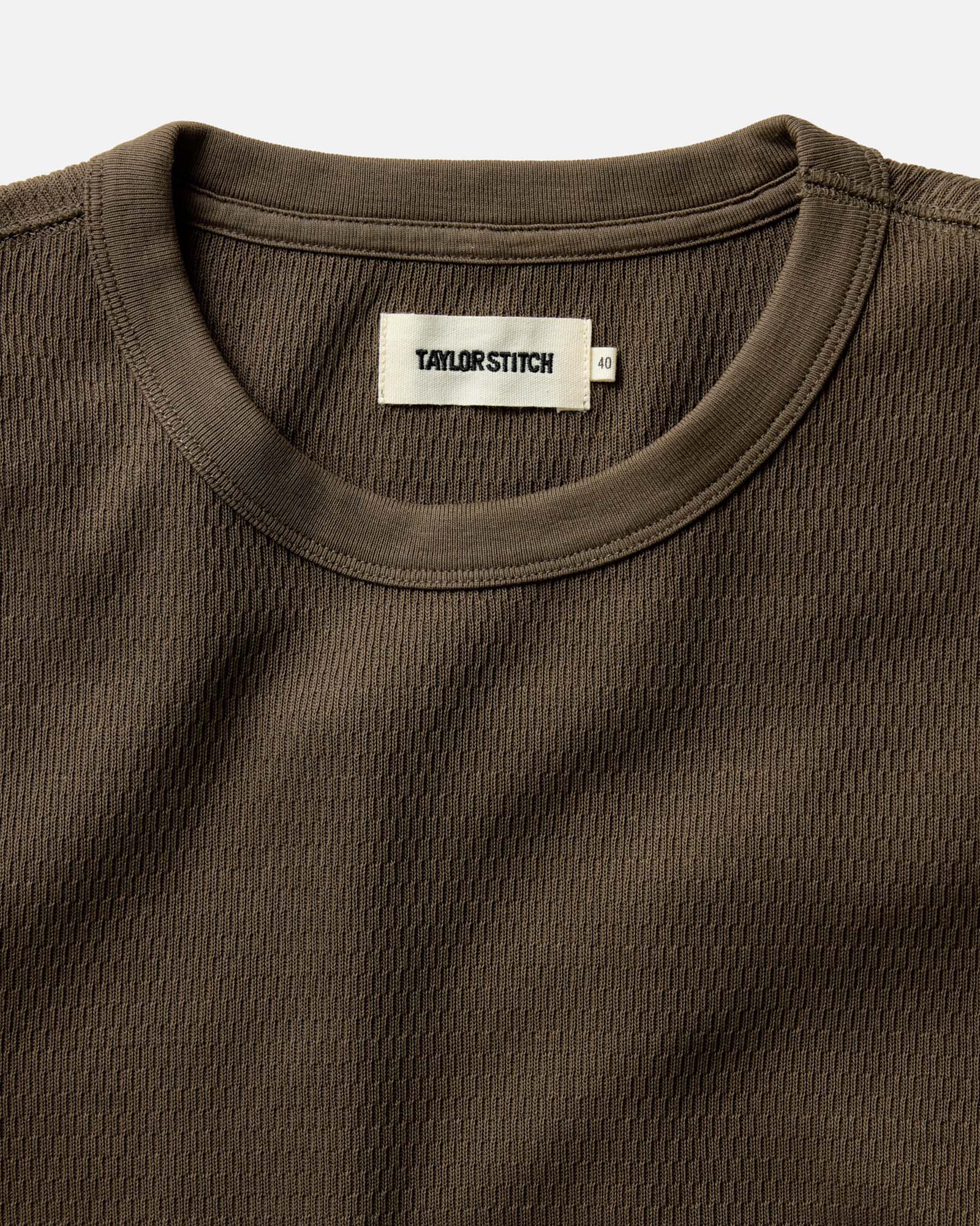fit model walking on a beach in The Organic Cotton Waffle Crew in Fatigue Olive, Knits by Taylor Stitch
