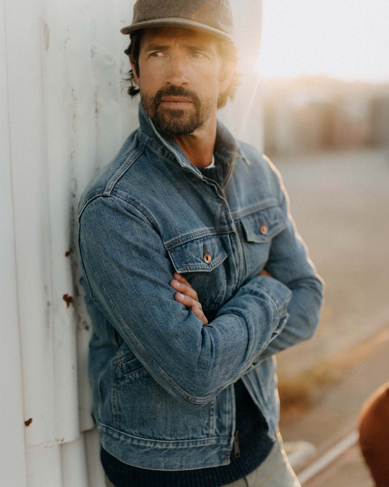 fit model leaning against the wall wearing The Roper Jacket in Vintage Wash Organic Selvedge, Outerwear by Taylor Stitch
