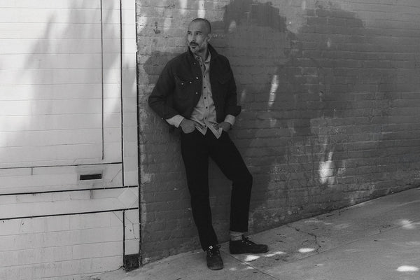 fit model posing in The Slim Jean in Rigid Black Organic Selvedge