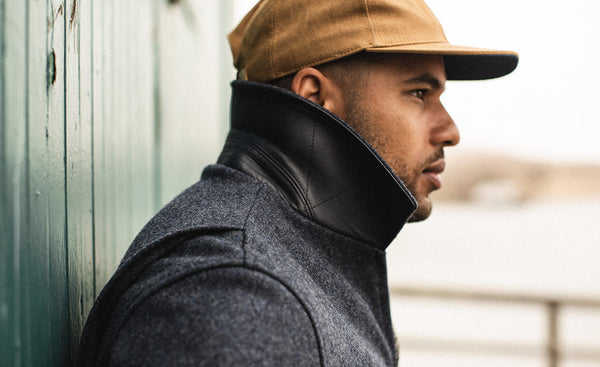 Side profile shot of our guy in a pop-collared bomber jacket.