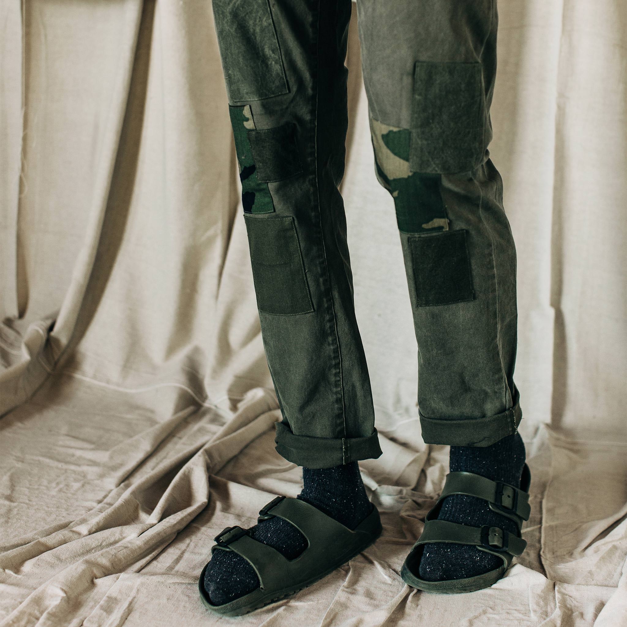 material shot of The Atelier and Repairs Chino in Olive, model standing diagonal, Bottoms by Taylor Stitch