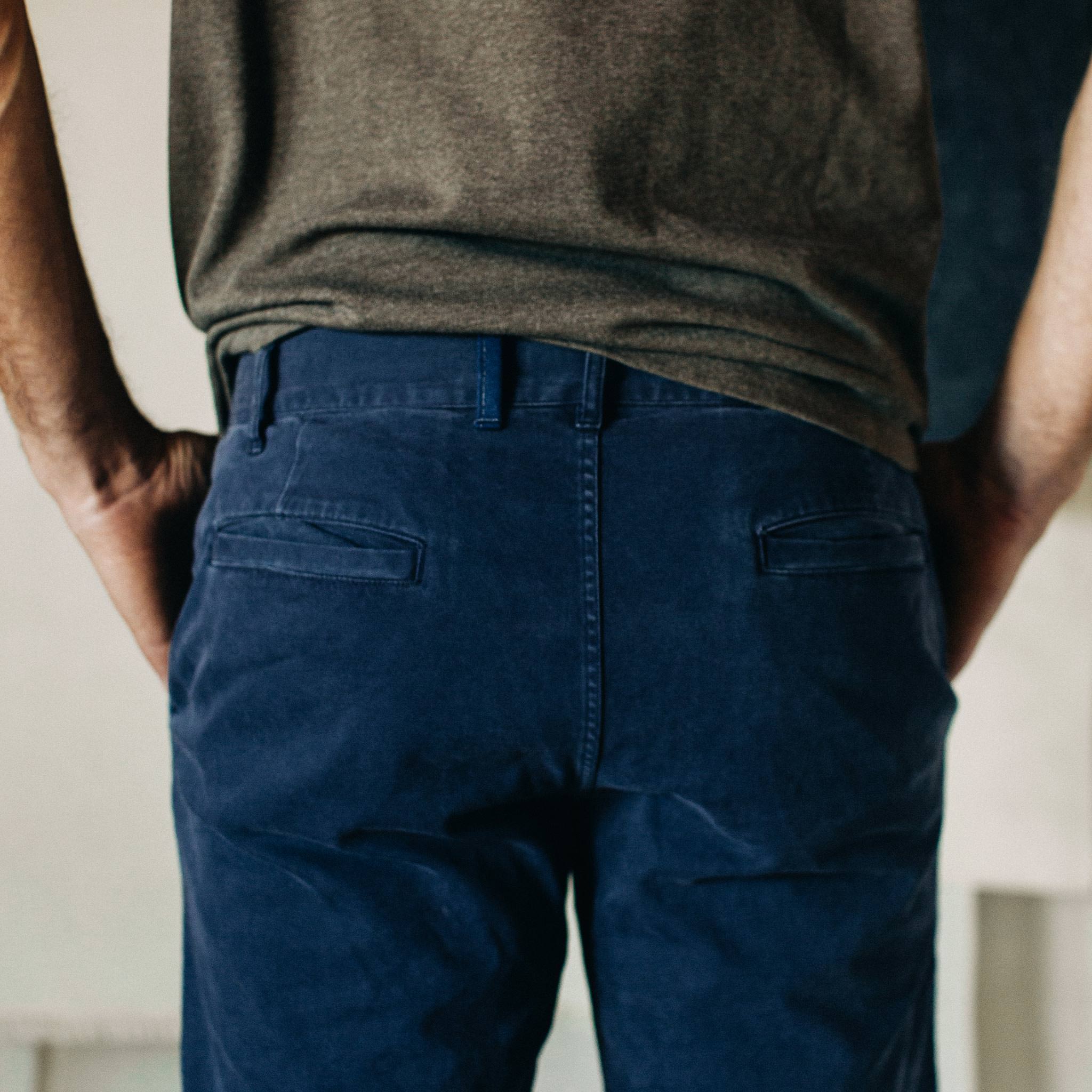 material shot of The Atelier and Repairs Chino in Navy, model facing opposite of camera, back shot, Bottoms by Taylor Stitch