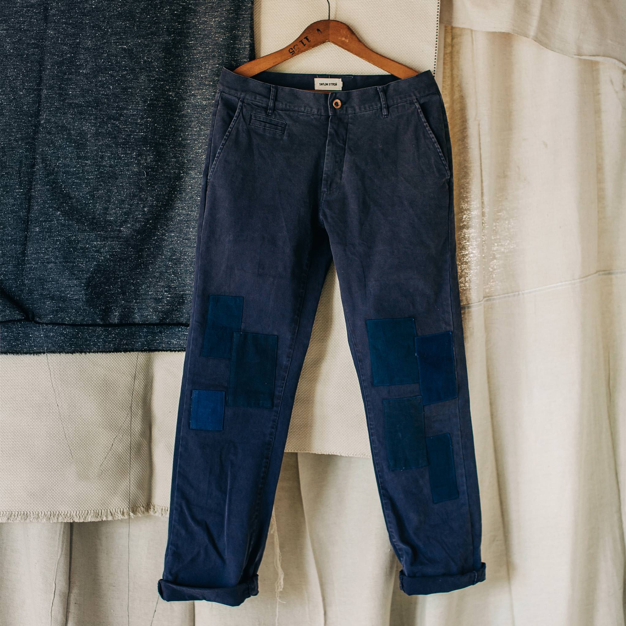 material shot of The Atelier and Repairs Chino in Navy, cuffed on hanger, Bottoms by Taylor Stitch