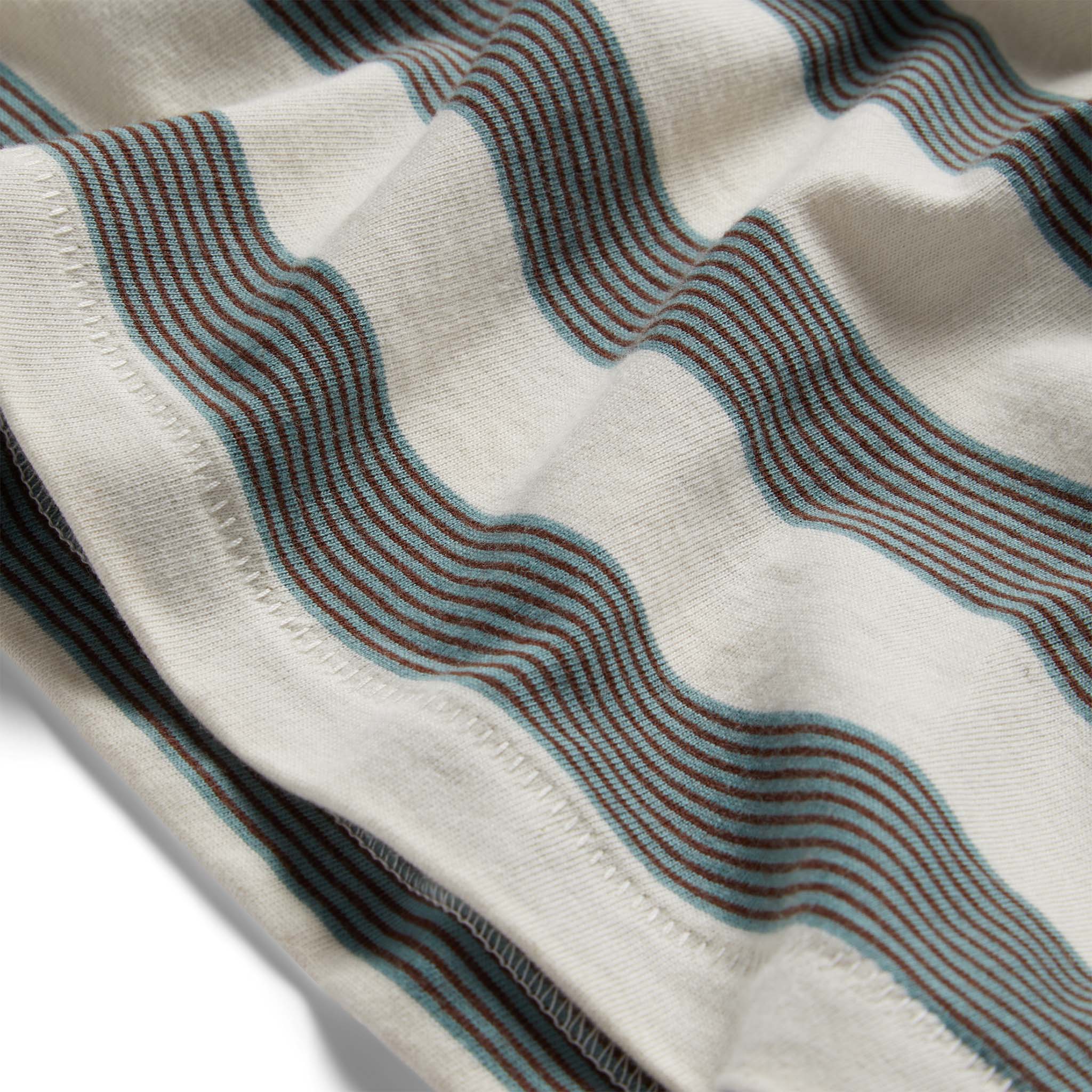 material shot of the hem on The Organic Cotton Tee in Natural and Ocean Stripe, Knits by Taylor Stitch