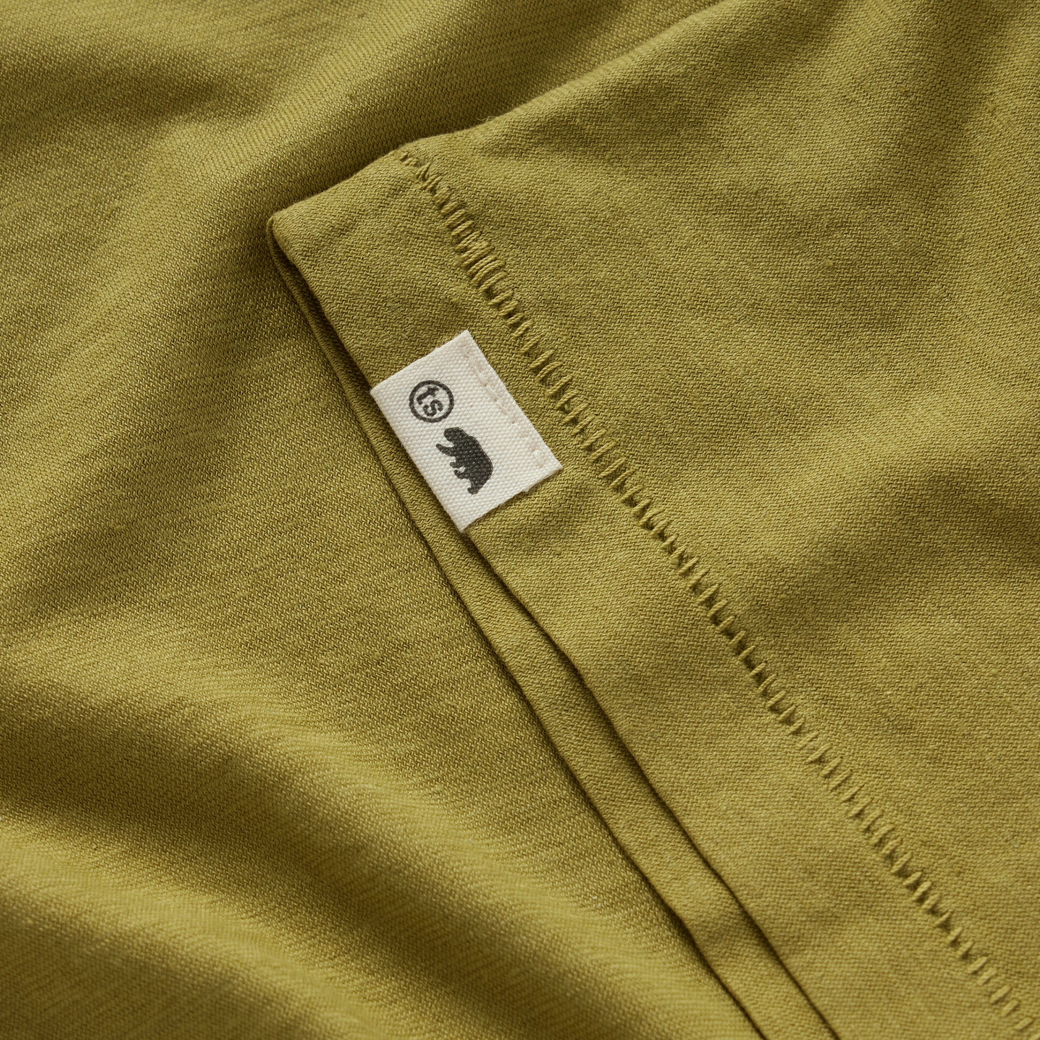 material shot of the TS tag on the sleeve of The Cotton Hemp Tee in Juniper, Knits by Taylor Stitch