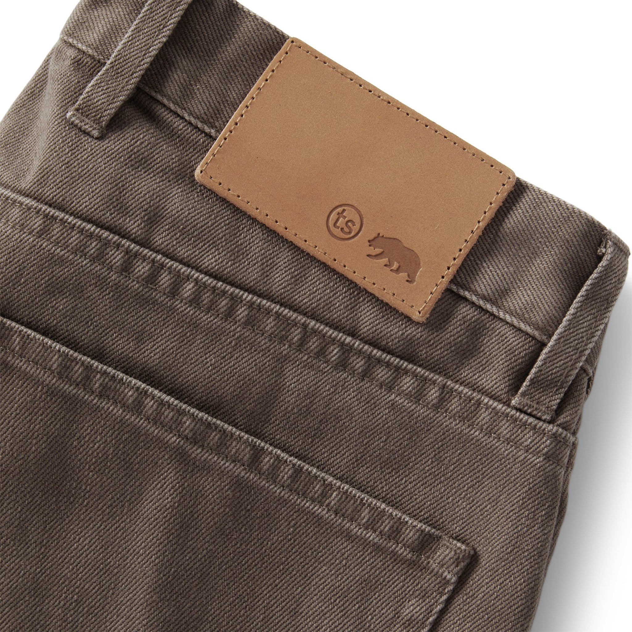 material shot of the leather patch on The Democratic All Day Pant in Washed Walnut Selvage, Bottoms by Taylor Stitch