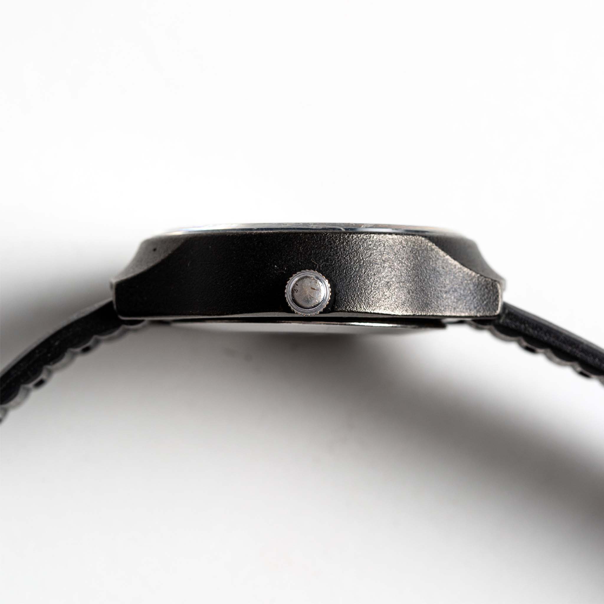 flatlay of the 1977 Timex Black Max, shown from the side, Accessories by Taylor Stitch
