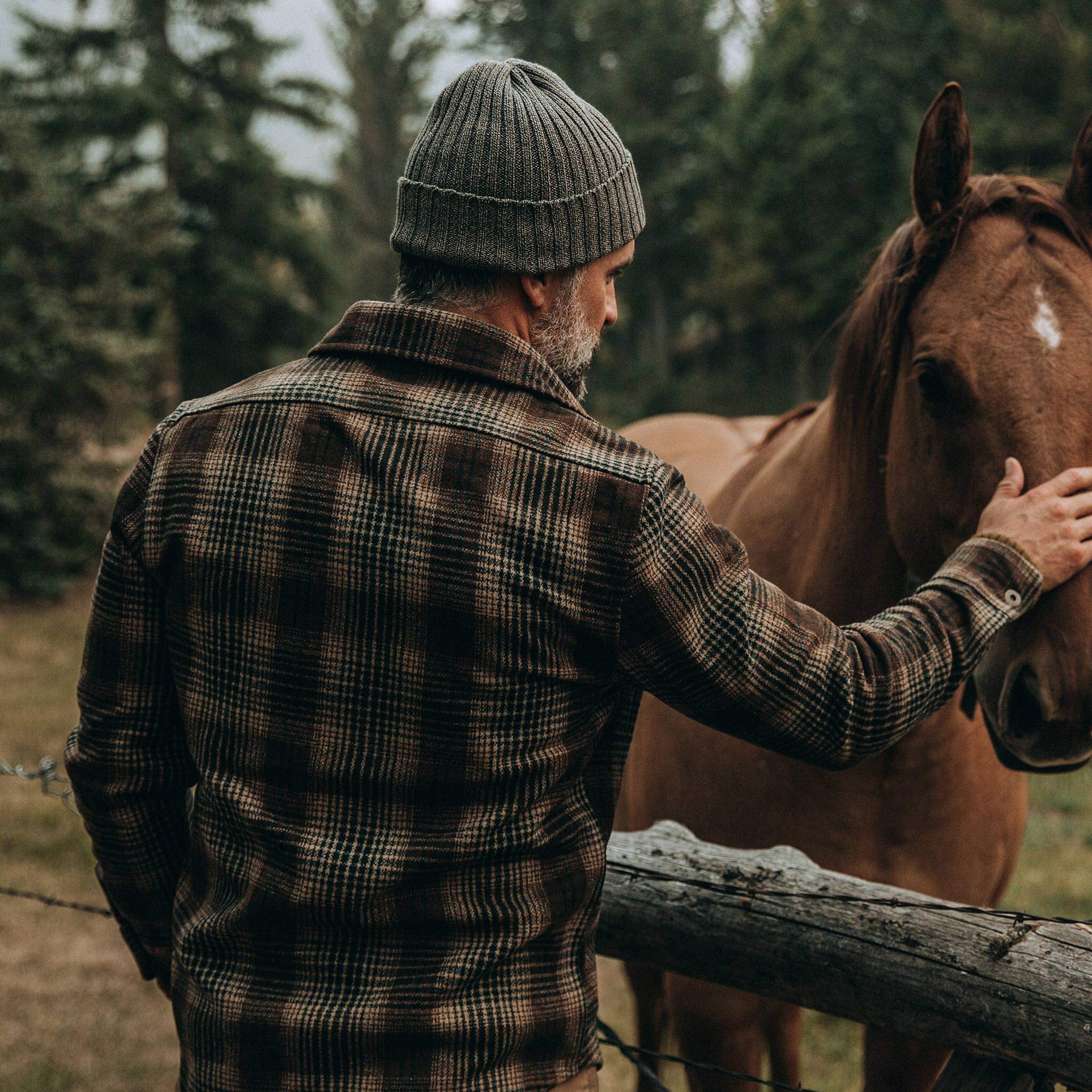 fot model wearing The Explorer Shirt in Tan Plaid, petting horse, Wovens by Taylor Stitch