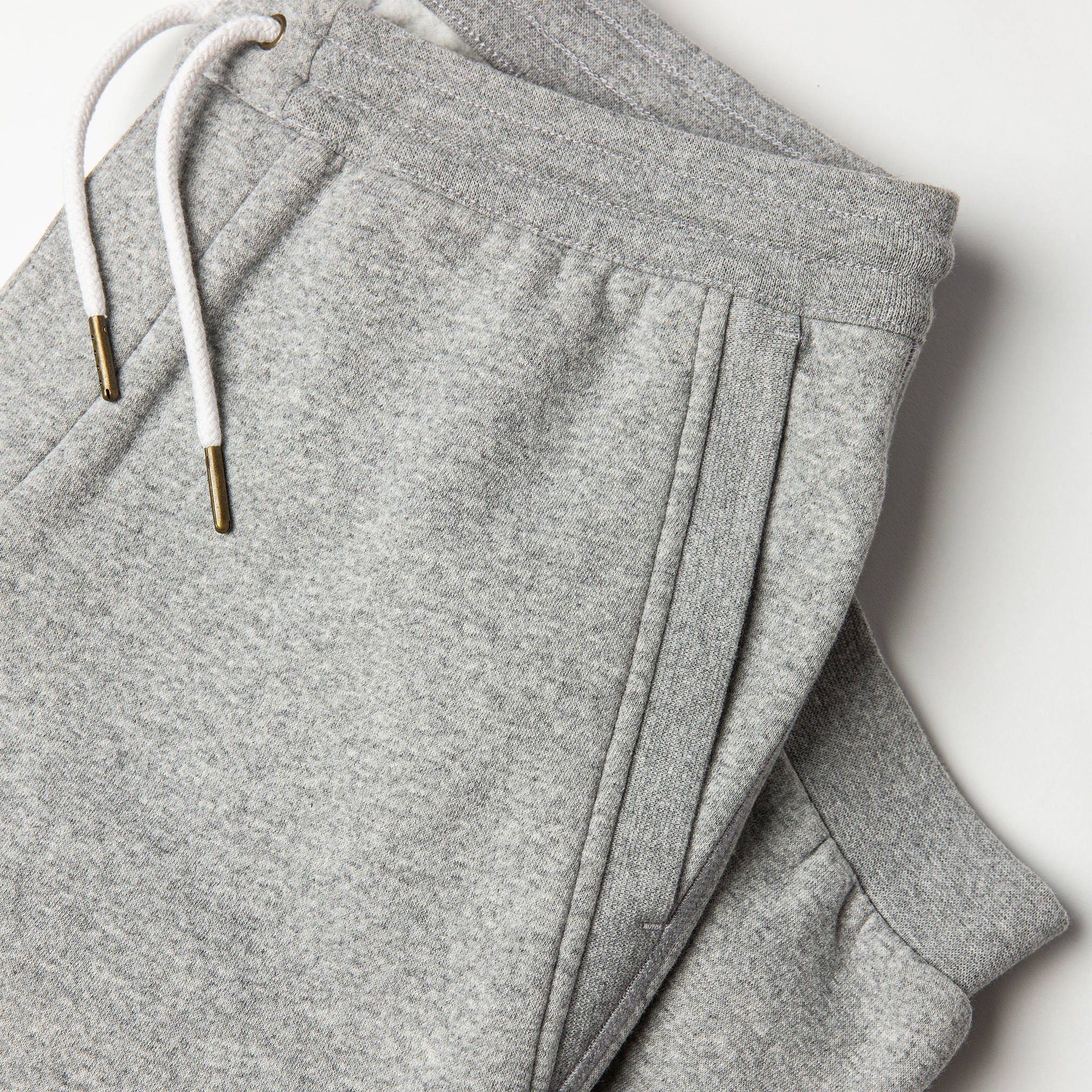flatlay of The Heavy Bag Pant in Heather Grey Fleece with diagonal reinforced hand pocket visible, Pants by Taylor Stitch