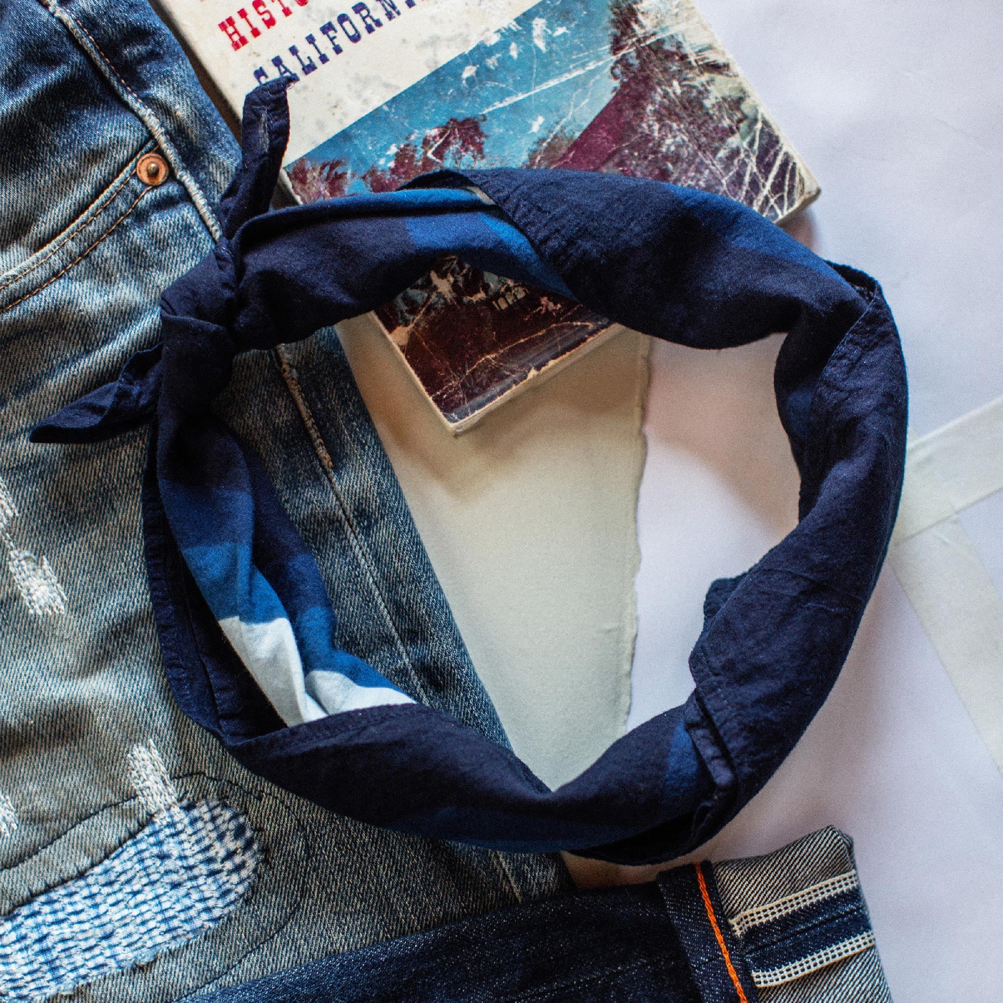 material shot of The Bandana in Natural Indigo Petal with its ends tied together., Accessories by Taylor Stitch
