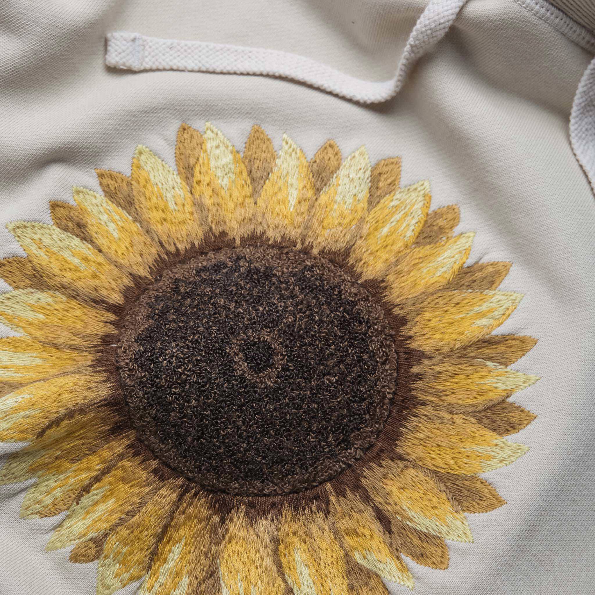 material shot close up of the embroidery of The Fillmore Hoodie in Sunflower Embroidery, Knits by Taylor Stitch