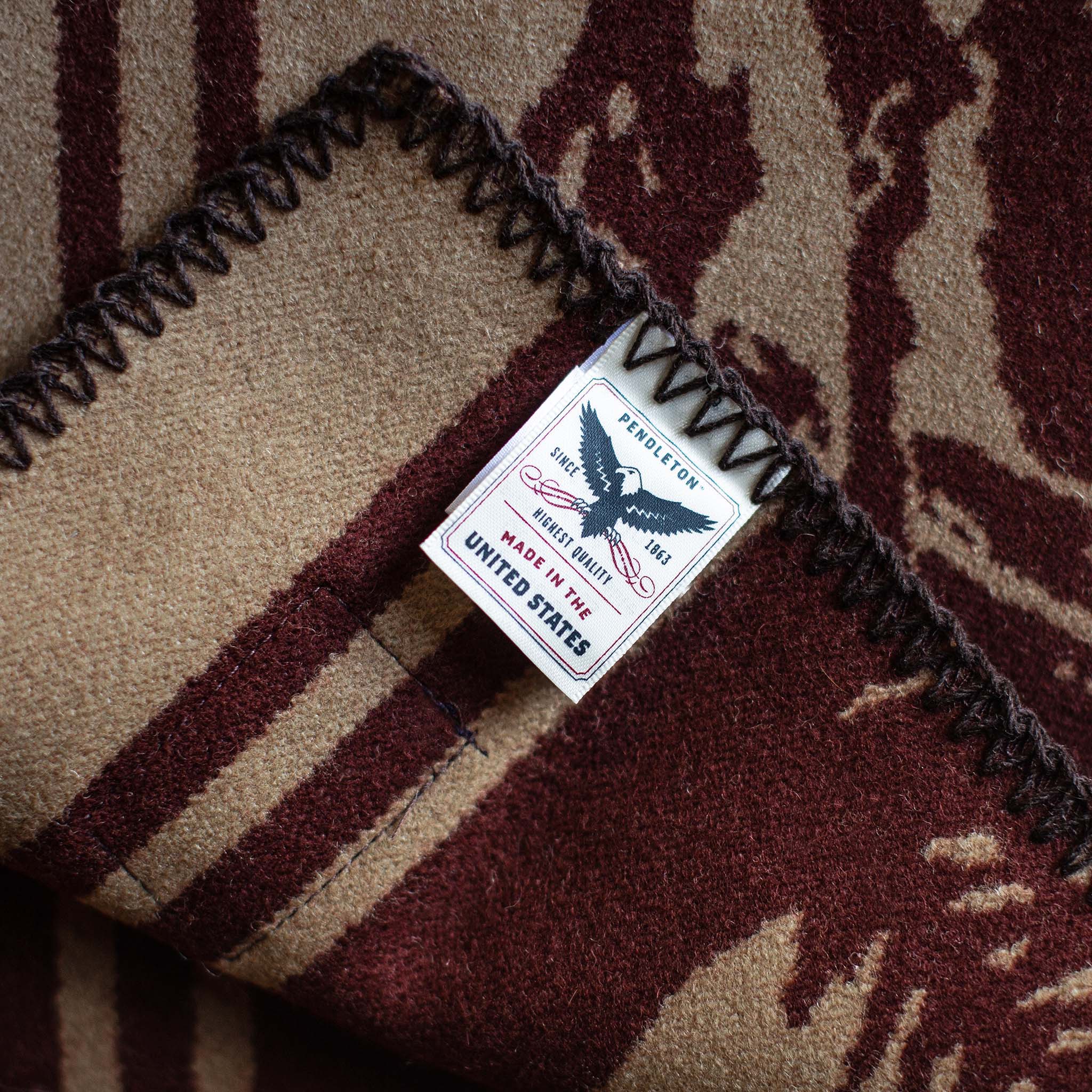 material shot of The Golden State Blanket in Rust's Pendleton tag, Accessories by Taylor Stitch